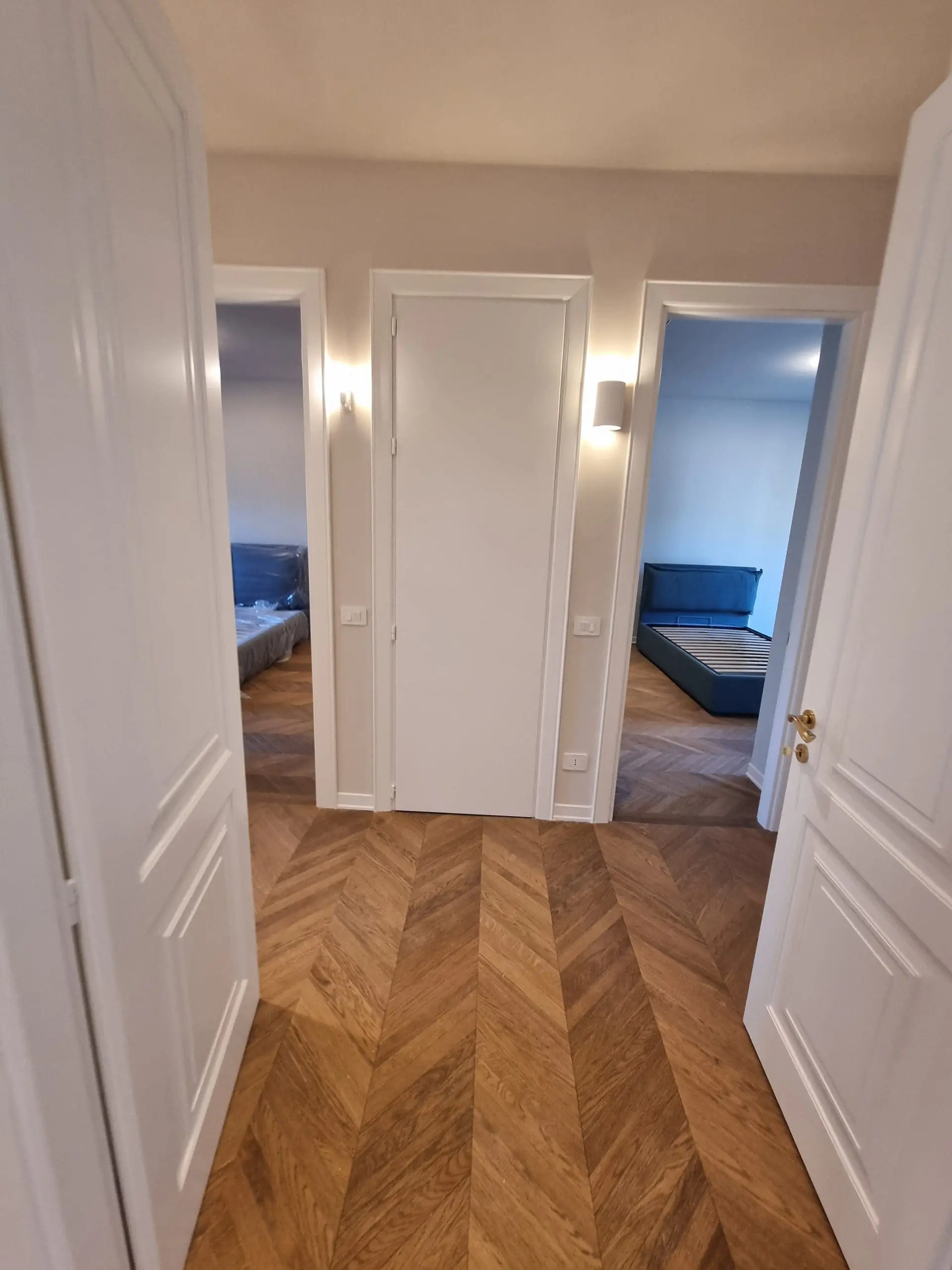 Porte interne: come scegliere tipologia, materiale, posa (guida 2026) 2 Zona notte dell'appartamento 120 mq in zona Cenisio dopo la ristrutturazione, con porte interne Garofoli laccate bianche, parquet e carta da parati — cantiere Mediolanum Ristrutturazioni Milano